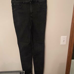 Black skinny jeans with distressed ankle